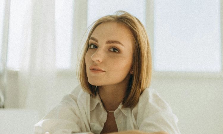 Woman with short hair in a white room