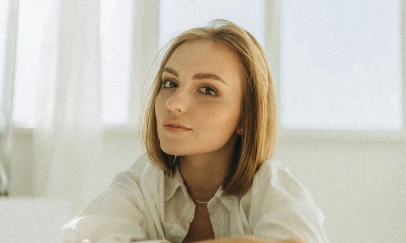 Woman with short hair in a white room
