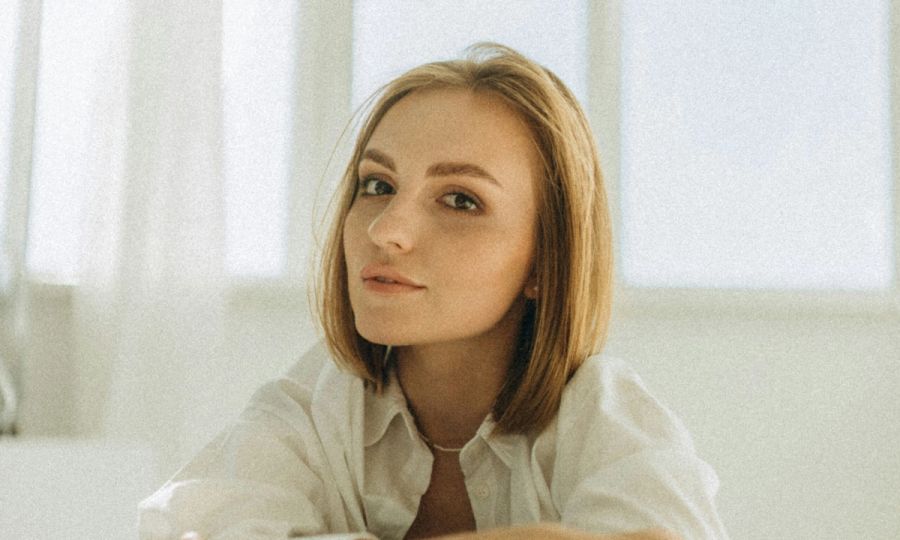 Woman with short hair in a white room