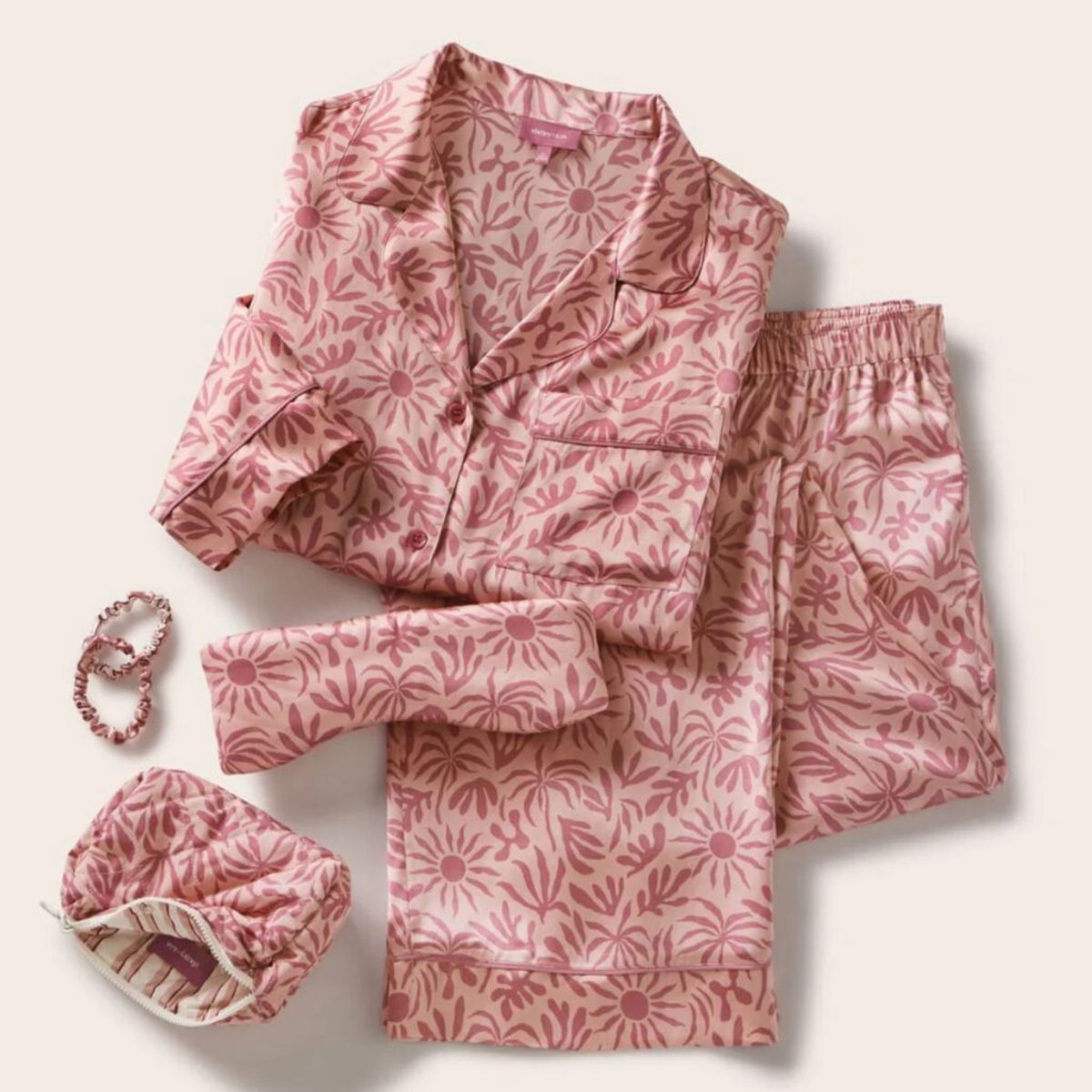 Eberjey x ILIA washable silk pajama set in pink palm print with matching eye mask, pouch and scrunchies from the Silk Rituals collection.