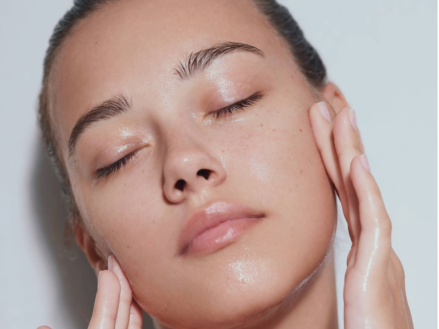 woman with clear skin touching face