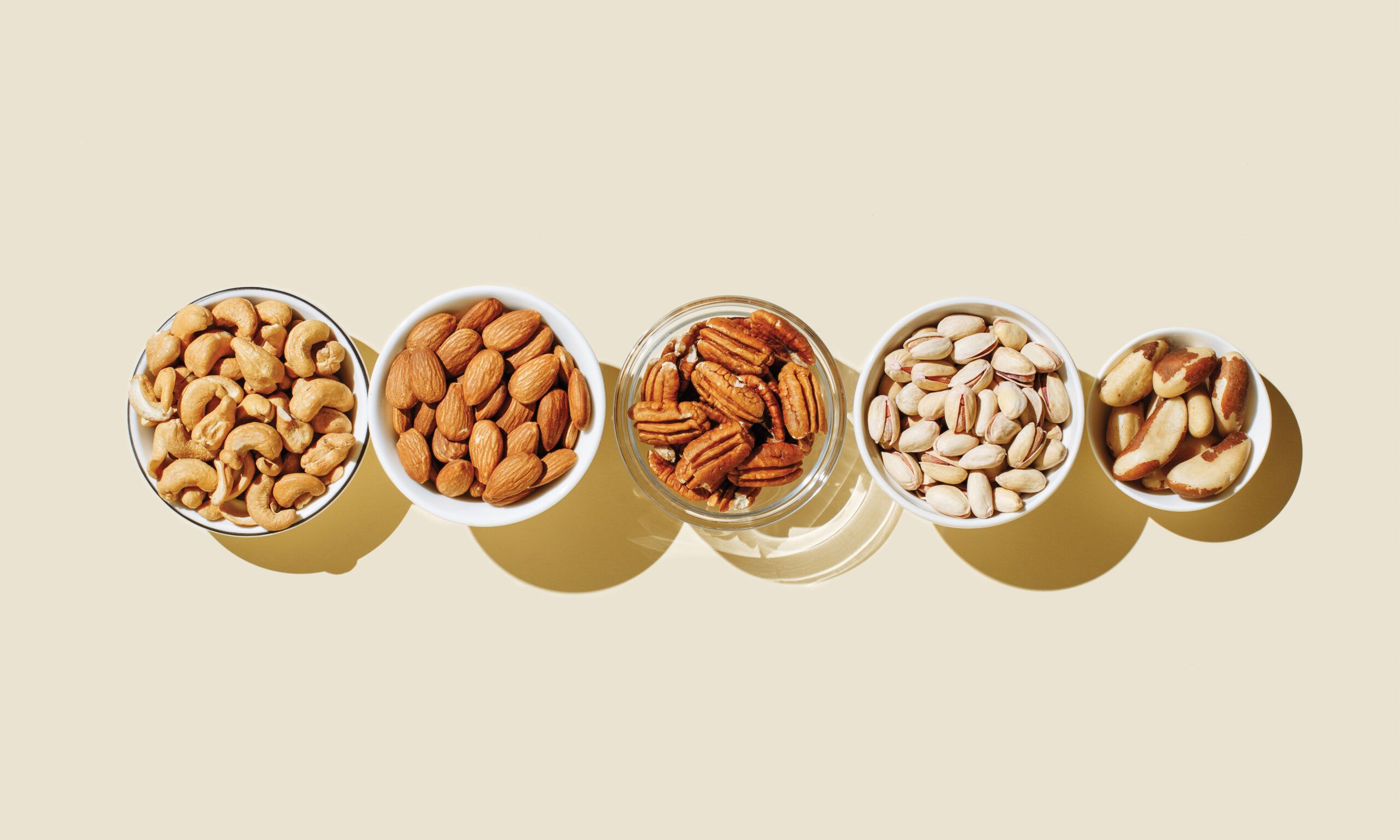 bowl of nuts on beige background