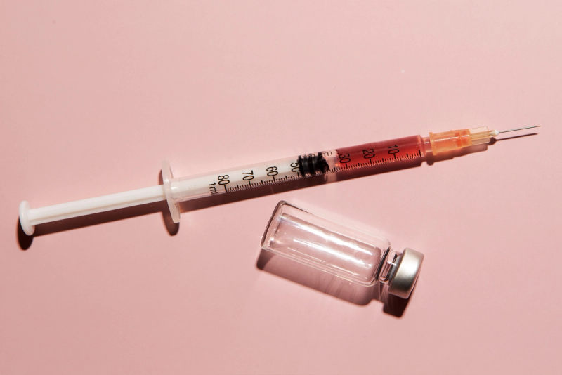 syringe on pink background