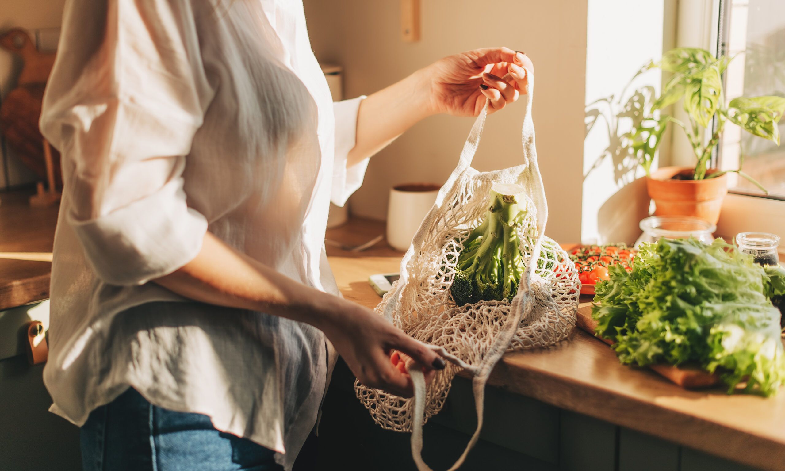 woman unloading-vegetables from market bags