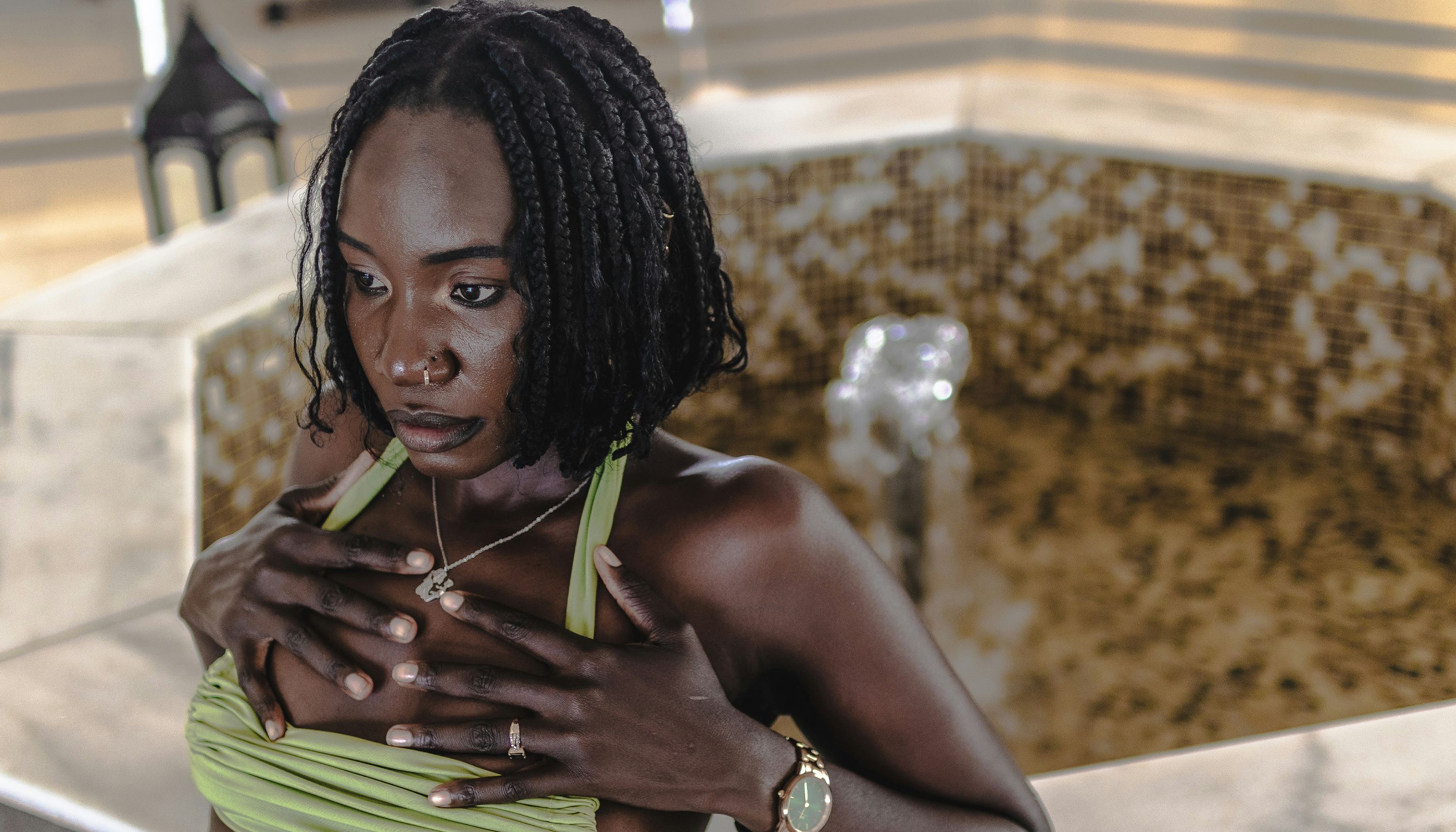 woman-in-green-dress-holding-chest