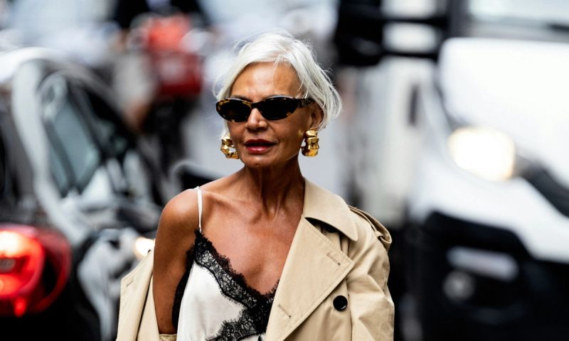 older woman standing in street