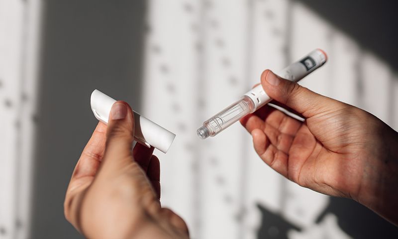 Semaglutide injection pen or cartridge pen for diabetics and weight loss in female hand. Medical equipment for diabetes patients