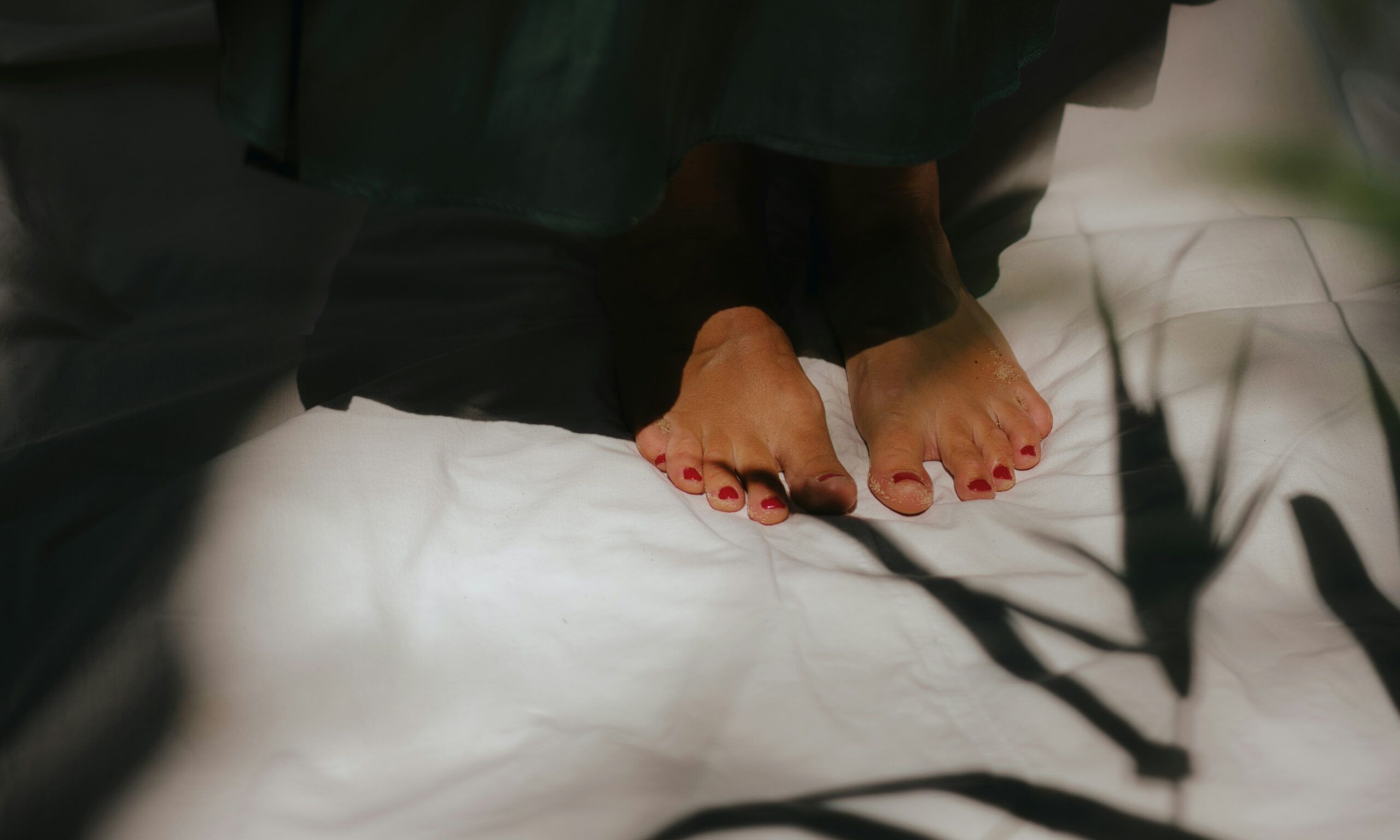 woman's feet with red nail polish