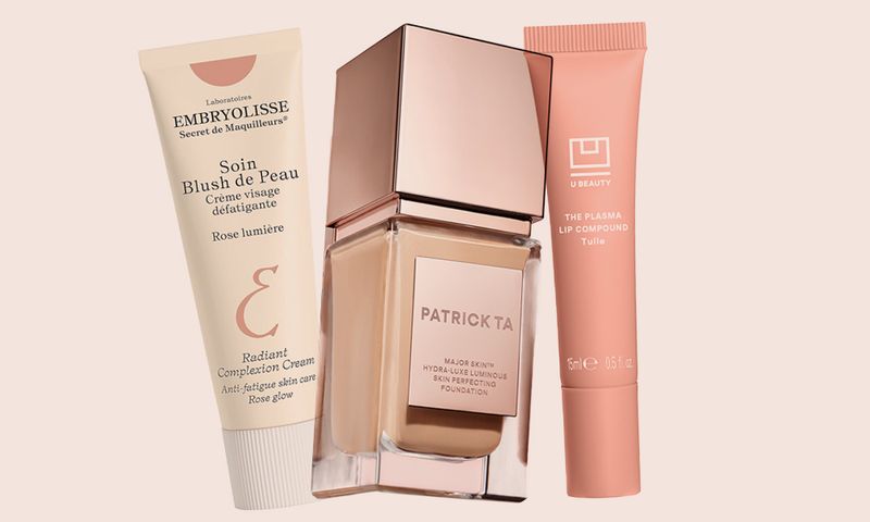 Various beauty products on an off-white to beige background