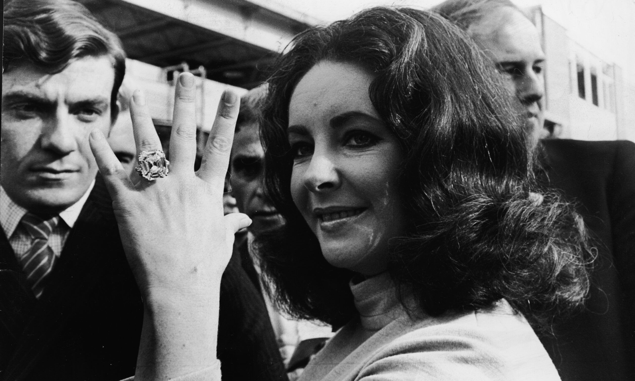 British-born actress Elizabeth Taylor shows off the 33.19 carat diamond ring given to her by husband Richard Burton.
