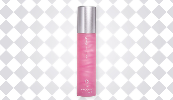 Pink bottle of ARCONA Cranberry Toner with a silver cap against a white-and-gray diamond-patterned background.
