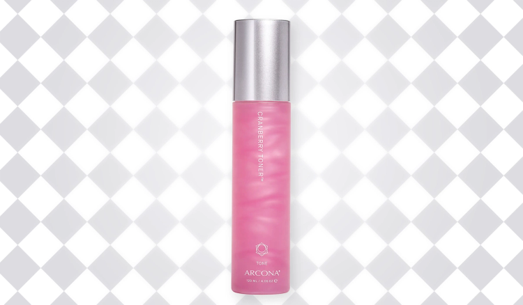 Pink bottle of ARCONA Cranberry Toner with a silver cap against a white-and-gray diamond-patterned background.
