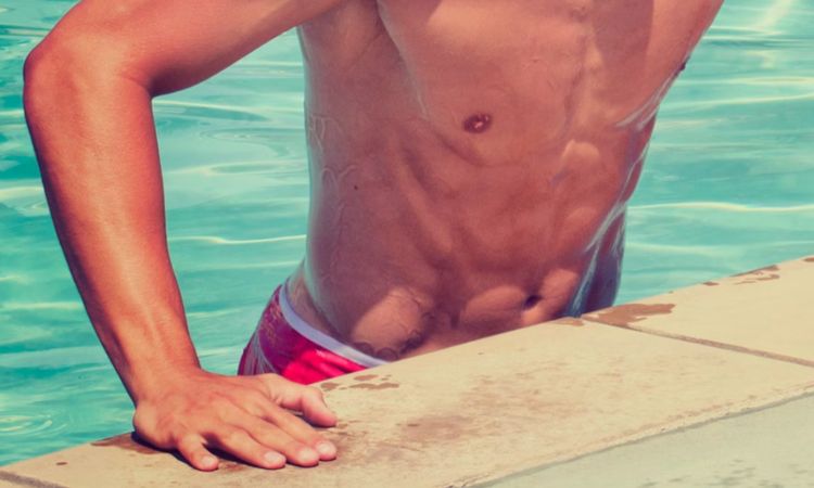 male abs coming out of a pool