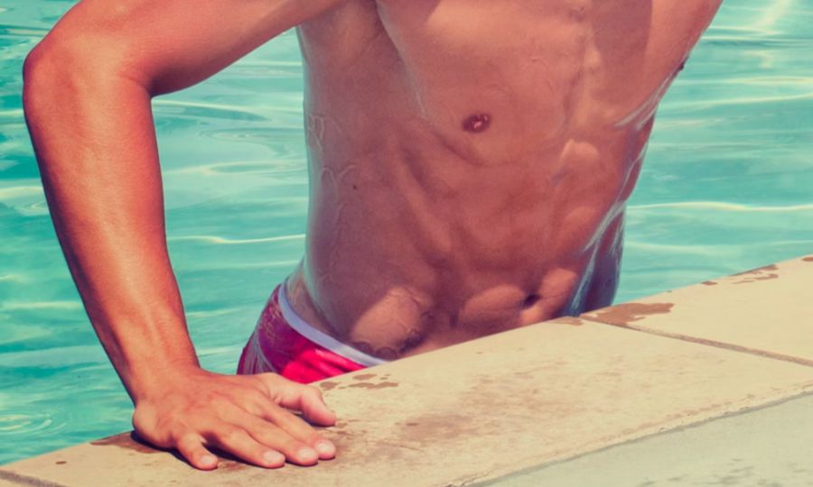 male abs coming out of a pool
