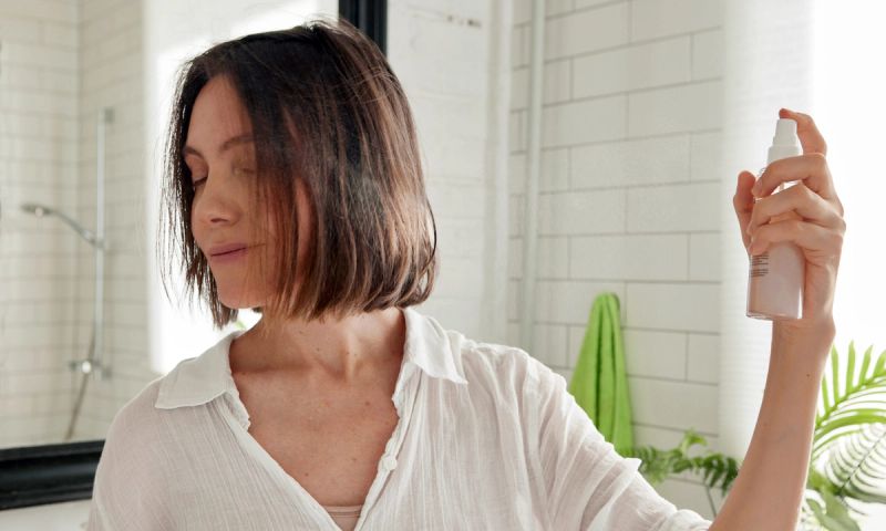 woman spraying short hair