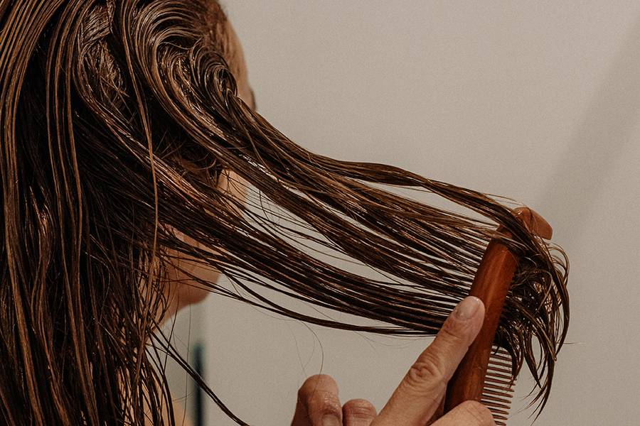 woman combing wet hair