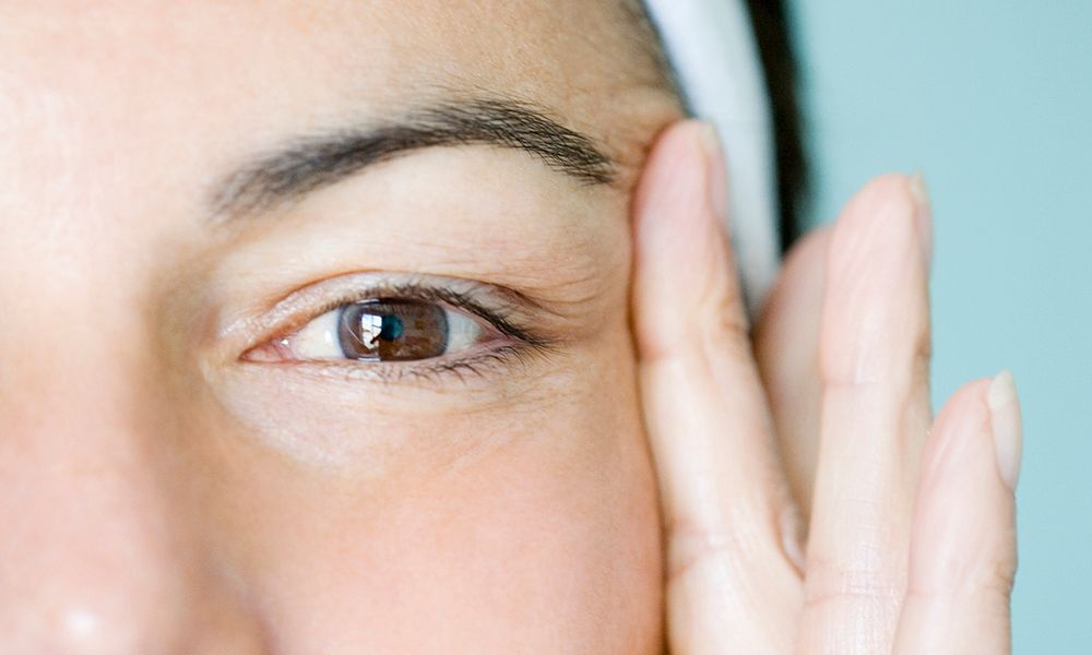 Woman pulling skin of the face