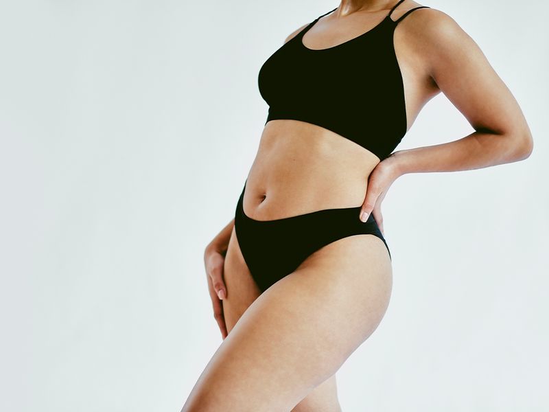 mid-view woman's body with black bralette and underwear