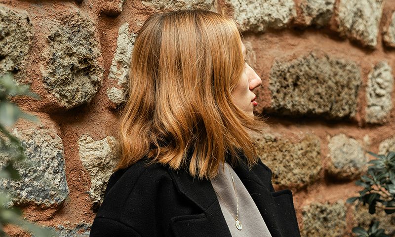 woman outdoors looking sideways showing hair