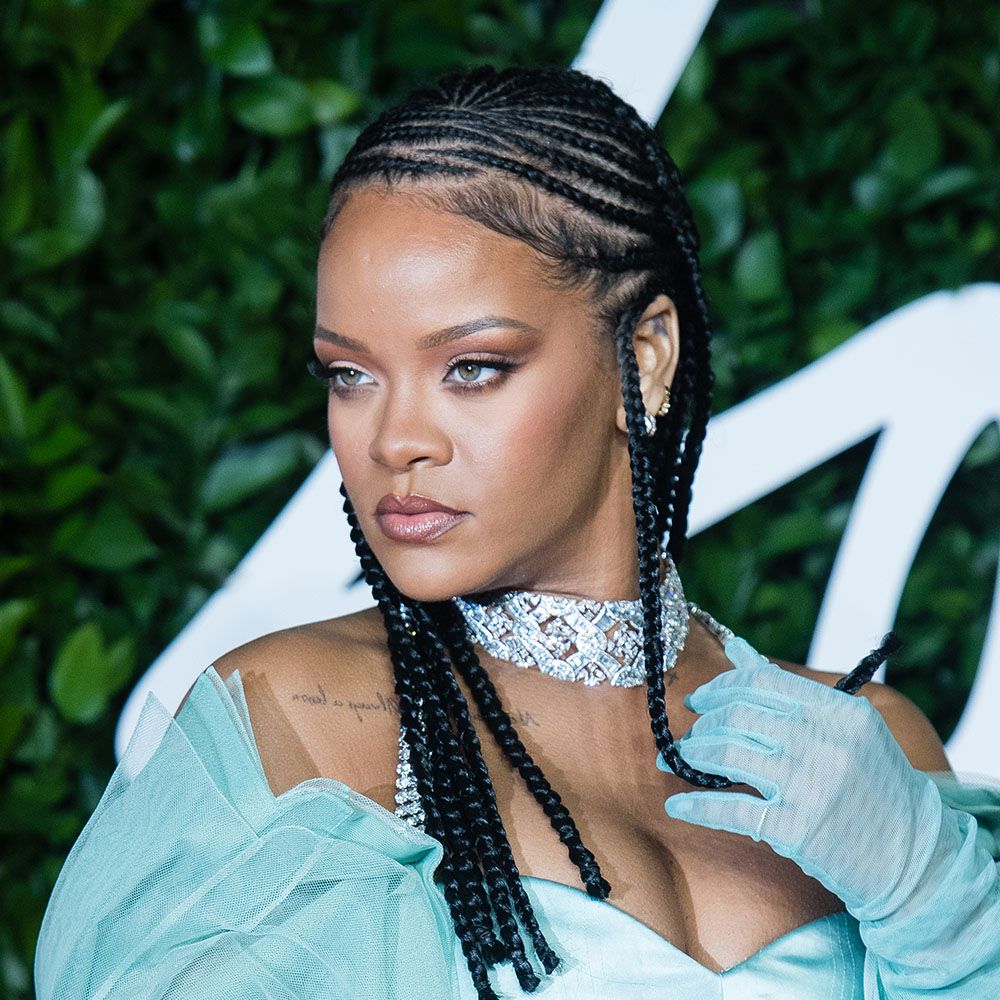 Rihanna wearing teal dress and gloves, diamond necklace and fulani braids hairstyle