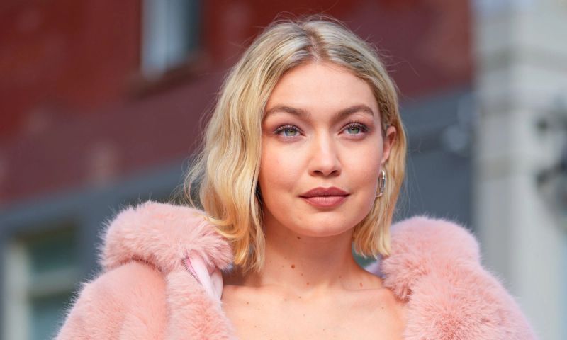 Close view of Gigi Hadid wearing a pink fur jacket