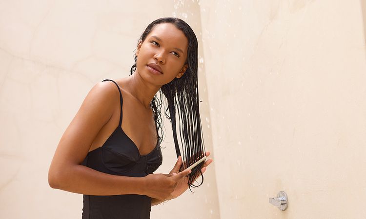 Long Hair Shower Relaxation: Woman Gently Combing Wet Hair Under Refreshing Water Stream. Calm, Reflective Mood, Emphasizing Self-Care, Tranquility, and Natural Beauty In Outdoor Setting. Ideal For Wellness And Beauty Themes.