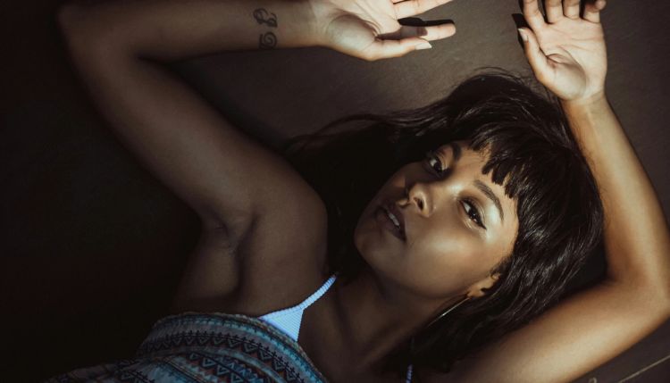 woman laying with arms up