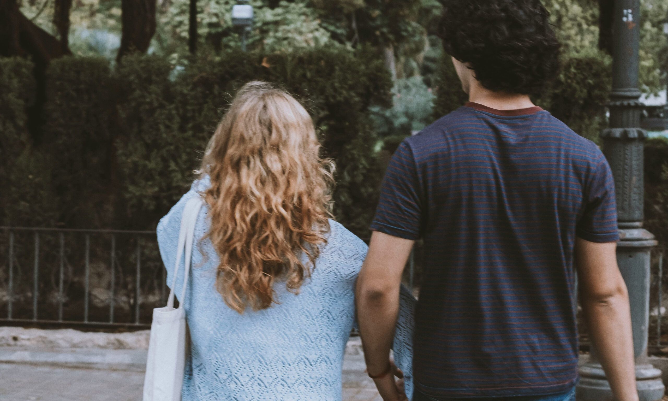 back view of man and woman walking outside