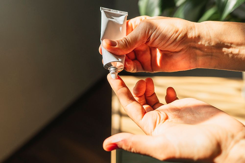 tube-of-skin-care-cream-on-finger