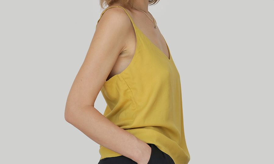 Close up portrait of Caucasian woman in yellow linen camisole shirt