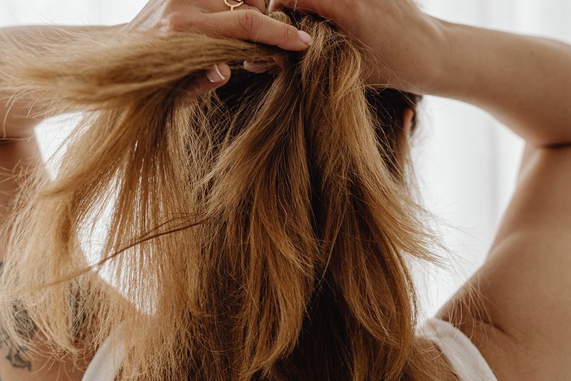 back-view-woman-putting-up-hair