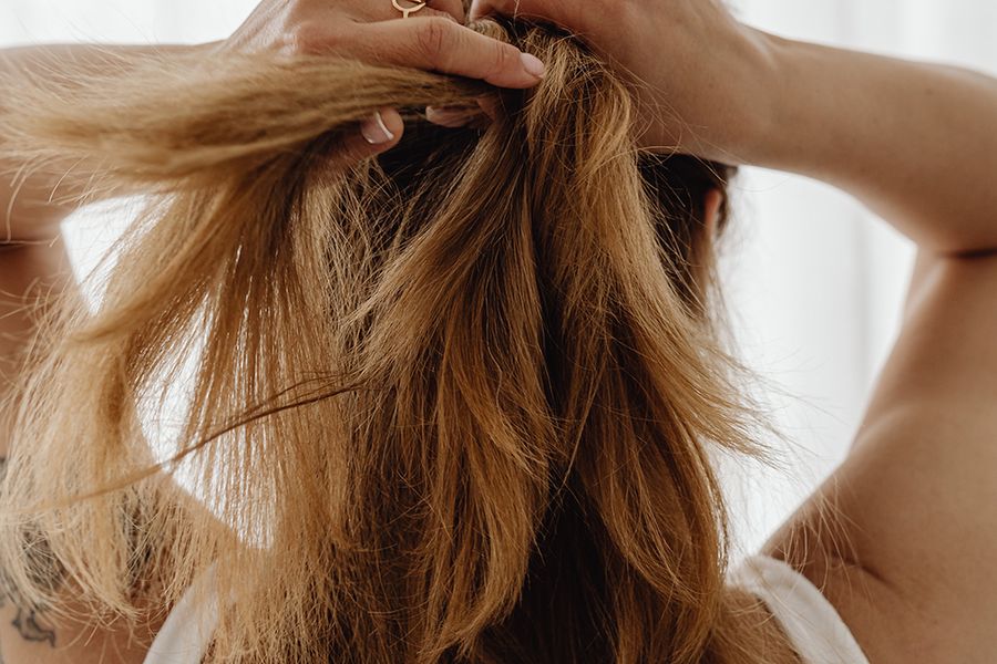 back-view-woman-putting-up-hair