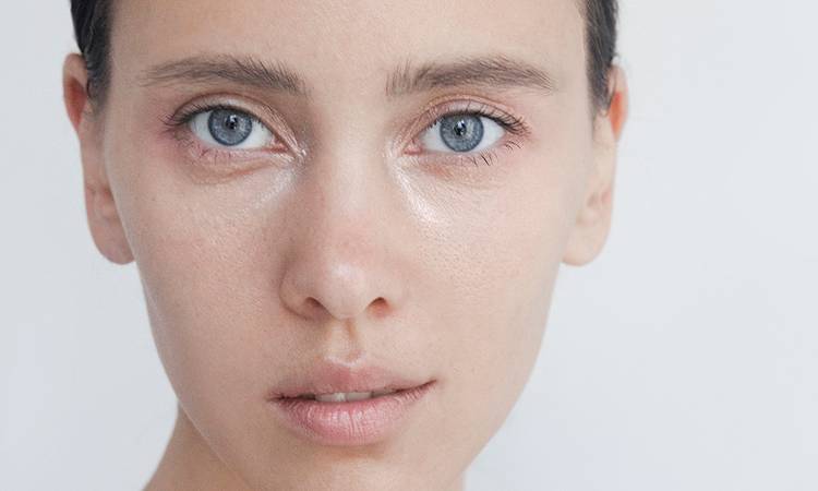 Beautiful young woman close-up portrait Captivating Brunette with blue eyes Pure Perfection Natural beauty Looking at camera Headshot Fashion model studio portrait Natural no-make-up look Soft skin Gentle kind look