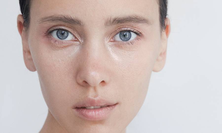 Beautiful young woman close-up portrait Captivating Brunette with blue eyes Pure Perfection Natural beauty Looking at camera Headshot Fashion model studio portrait Natural no-make-up look Soft skin Gentle kind look