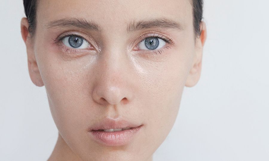 Beautiful young woman close-up portrait Captivating Brunette with blue eyes Pure Perfection Natural beauty Looking at camera Headshot Fashion model studio portrait Natural no-make-up look Soft skin Gentle kind look