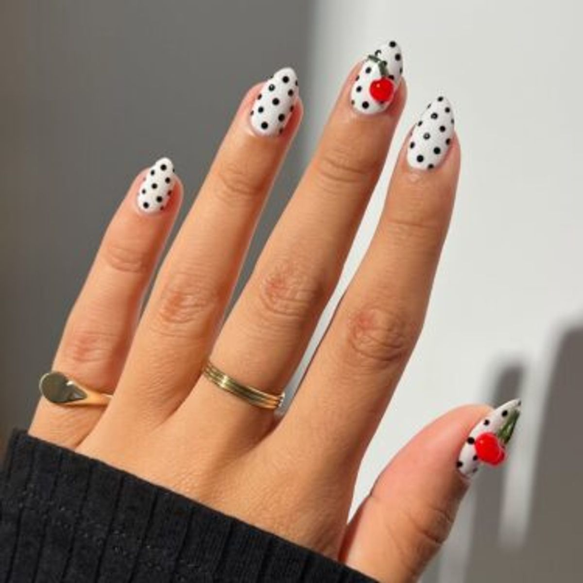 Black and white polka dot nails with cherry designs