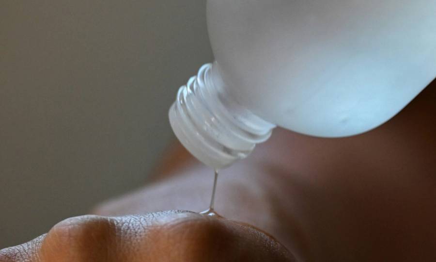 skin care liquid being poured on to hand