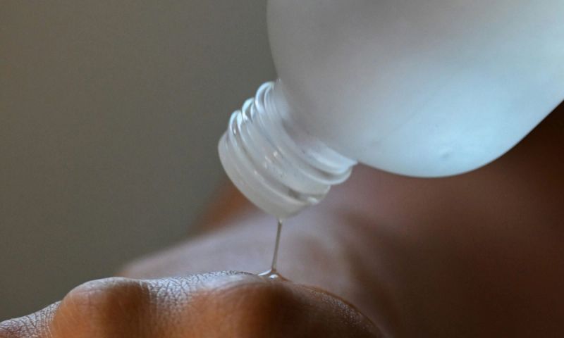skin care liquid being poured on to hand