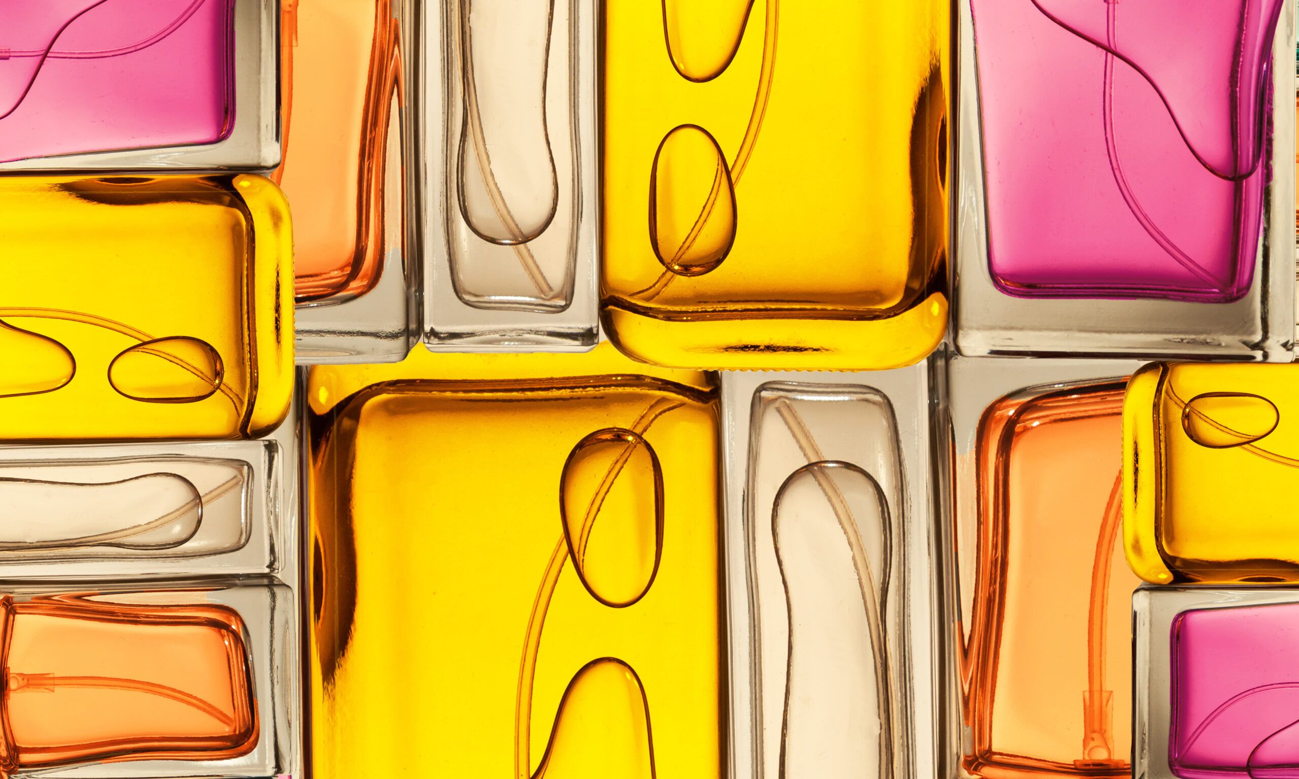 Top view, flat lay of a set of perfume bottles on a on a colorful background