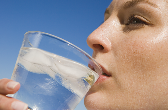 Woman outdoors drinking ice water