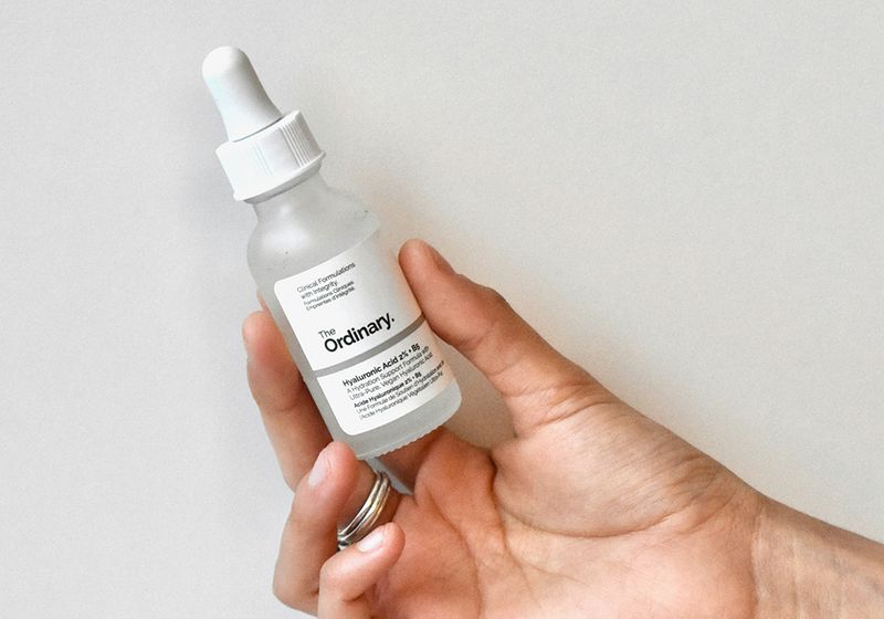 Hand holding The Ordinary serum