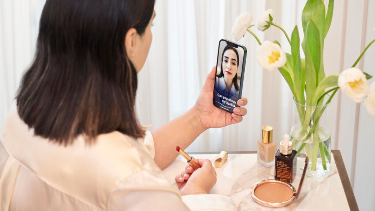Advertising image, woman using the VMA application to check her lipstick.