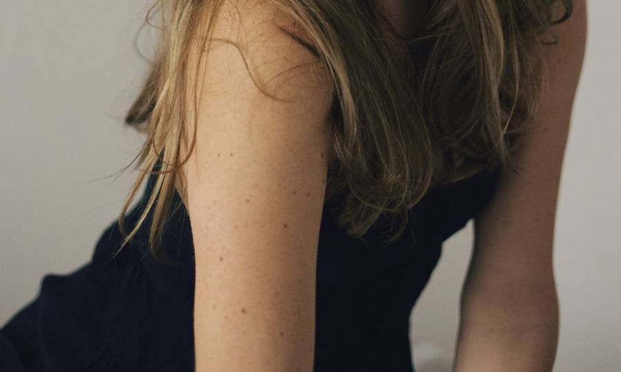 Woman in black short bare arms