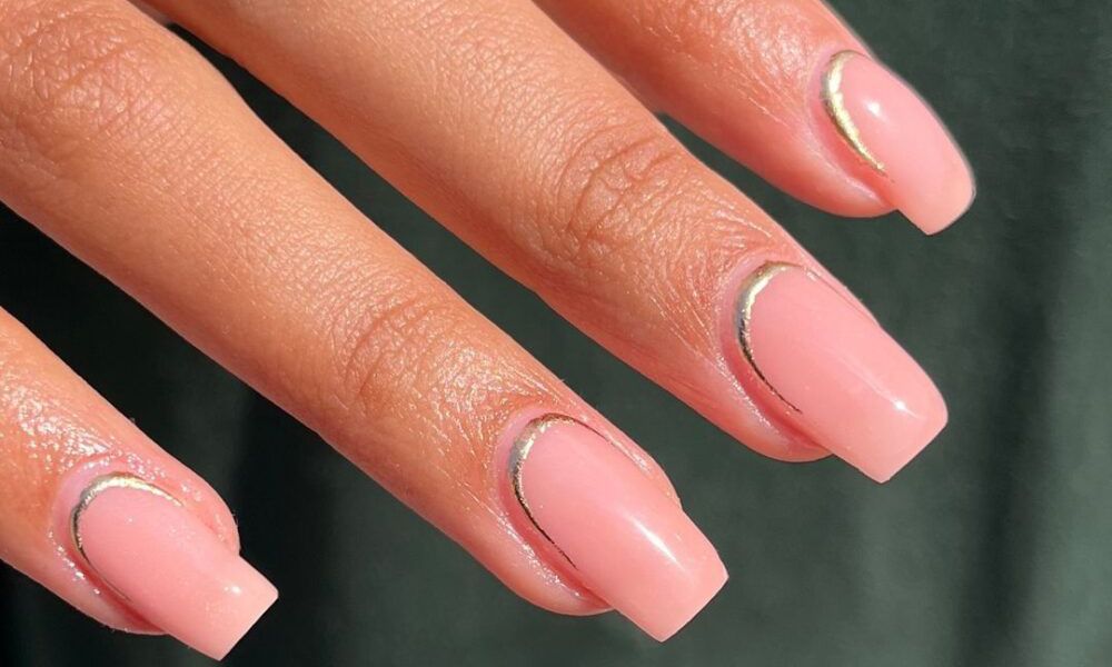 Manicured hand with a reverse french manicure