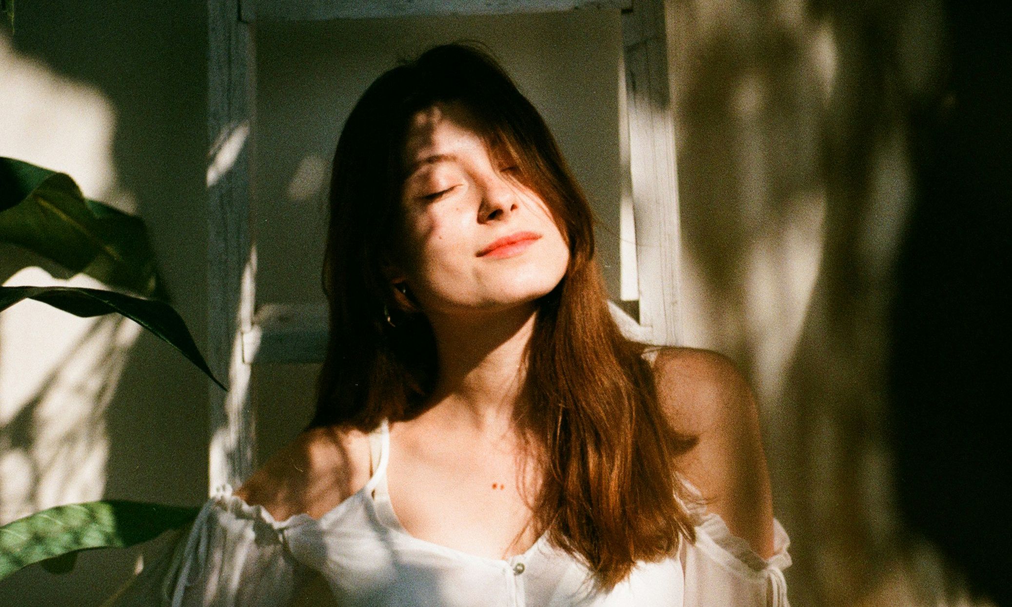 Woman with eyes closed with sunshine on her face