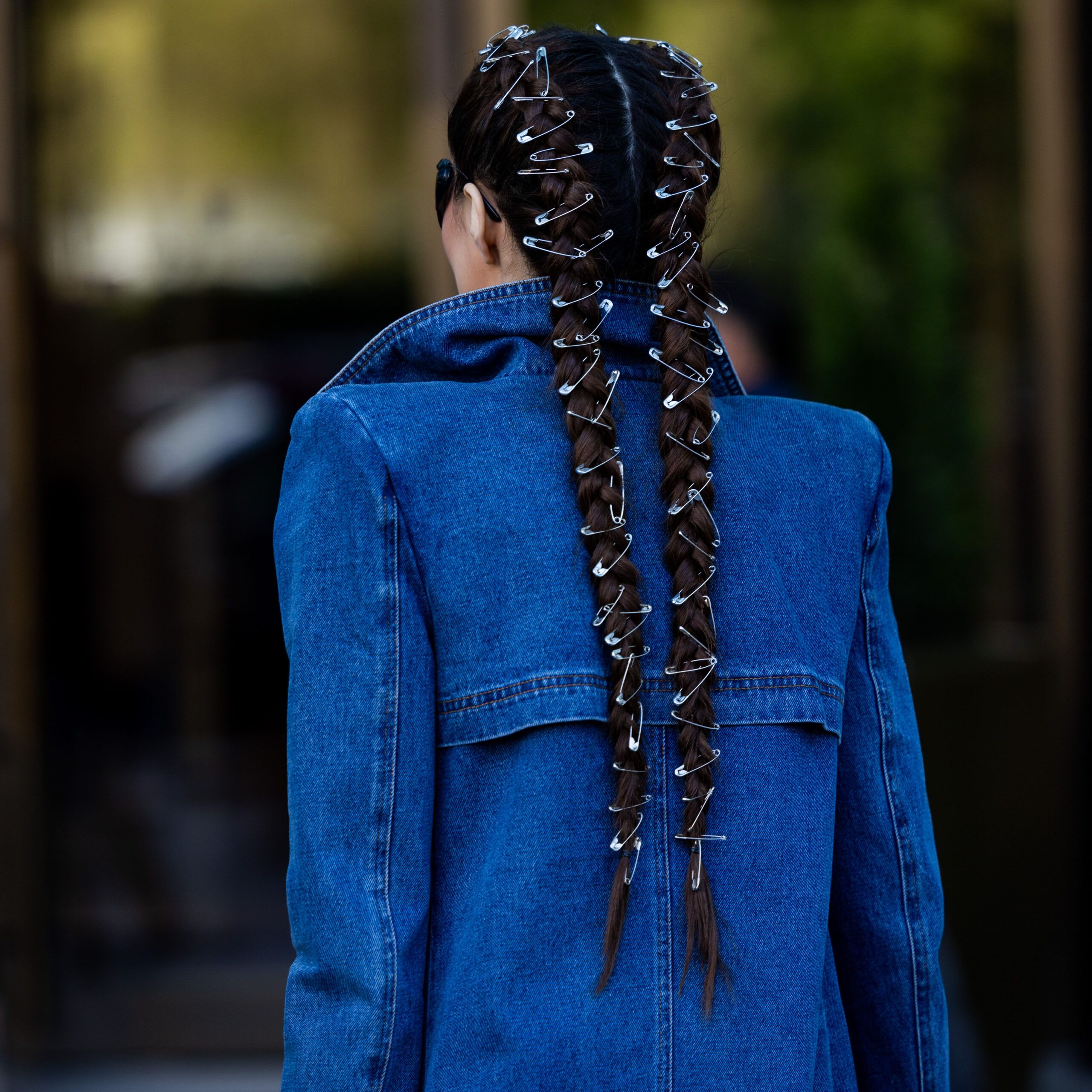 Back view of woman with french braids with safety pins