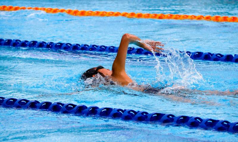 Swimmer swimming in Olympic size pool