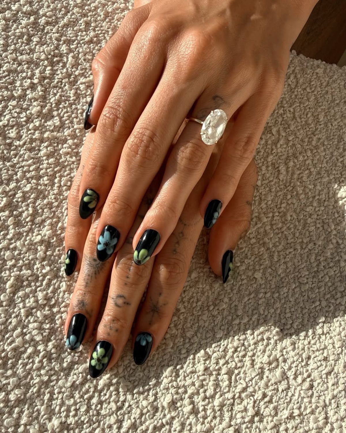 hailey bieber dark glow in the dark floral manicure