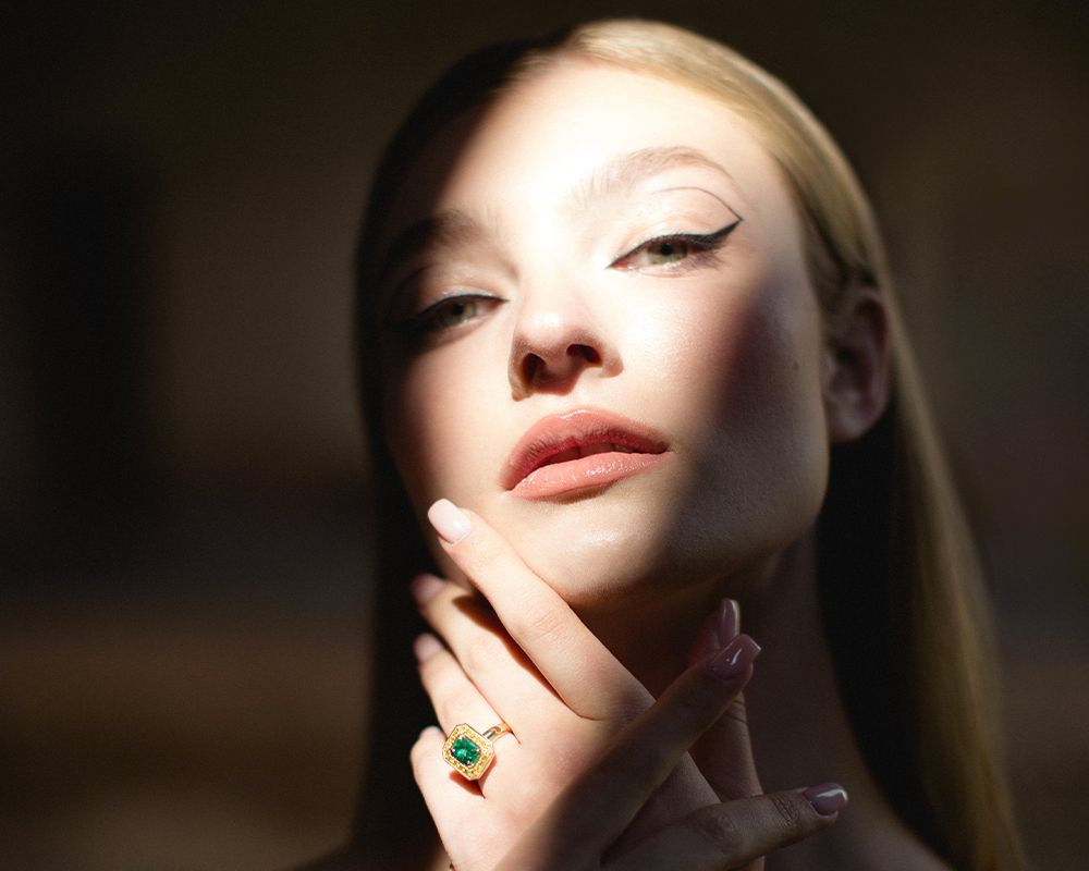 woman with hand touching face in shadows and light