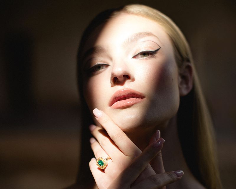 woman with hand touching face in shadows and light